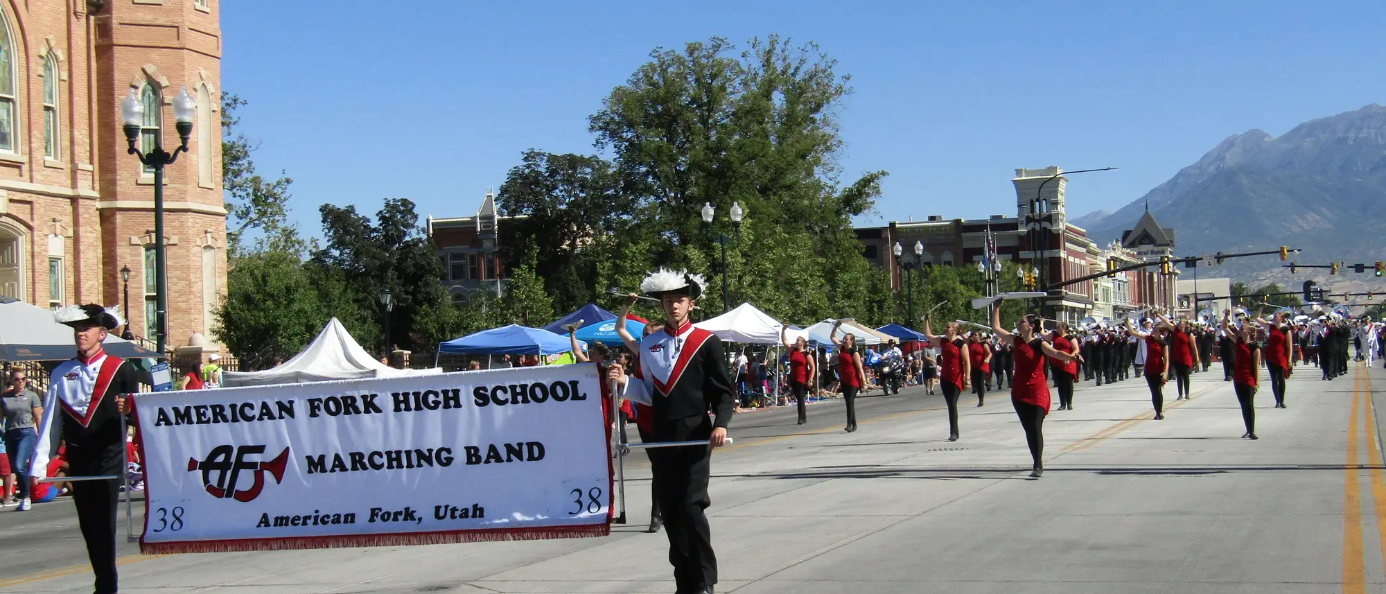 The American Fork High School marching band playing in parade formation.