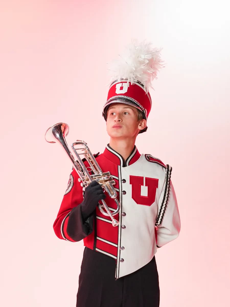 Sam Perillo in University of Utah Marching Utes uniform, holding a trumpet.